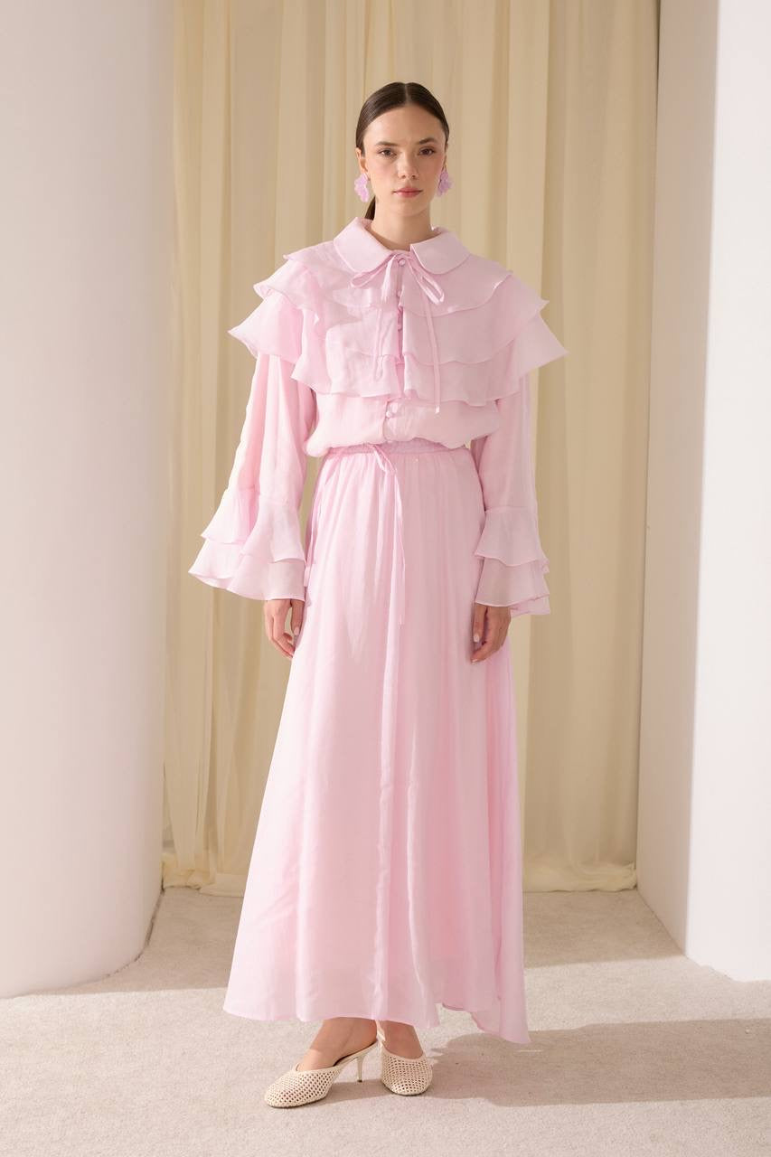 Elegant two-piece set featuring a layered blouse and a flowing skirt