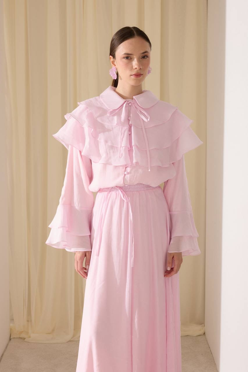 Elegant two-piece set featuring a layered blouse and a flowing skirt