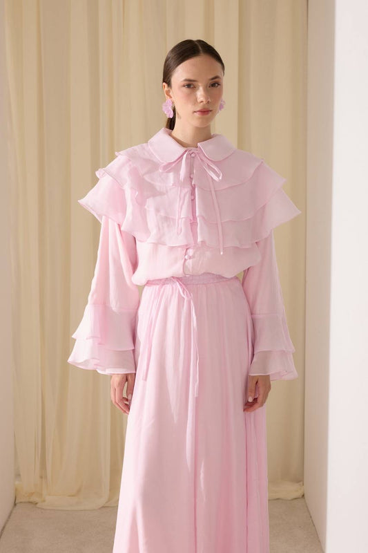 Elegant two-piece set featuring a layered blouse and a flowing skirt